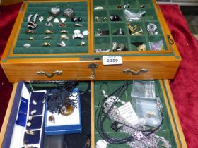 A large jewellery Box, with key, containing costume jewellery including rings, earrings,