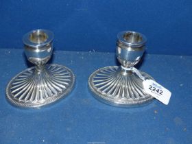 A pair of low Silver oval Candlesticks in classical style of fluted and bead decoration,