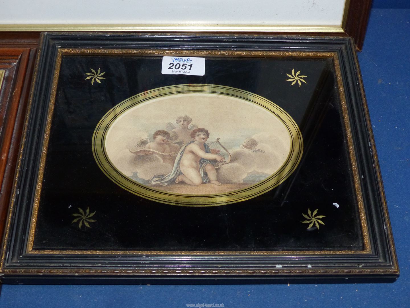 An oval Engraving of Cherubs in glomyized glass, a woman and child feeding chickens framed, - Image 2 of 3