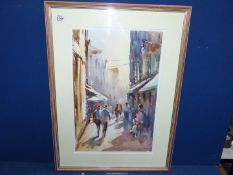 A large framed and mounted water colour depicting a Street Scene.