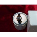 A ladies Radley boxed 'Watch it ladies' wristwatch with black dial and silicone strap, as new.