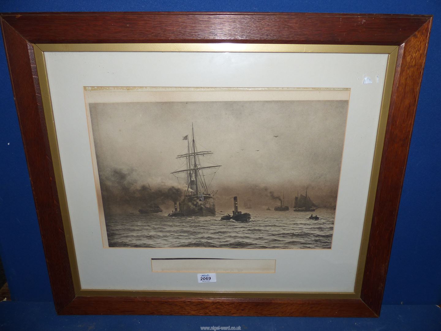 A large oak framed Lithograph 'In Tow' depicting large sailing ship coming into harbour,