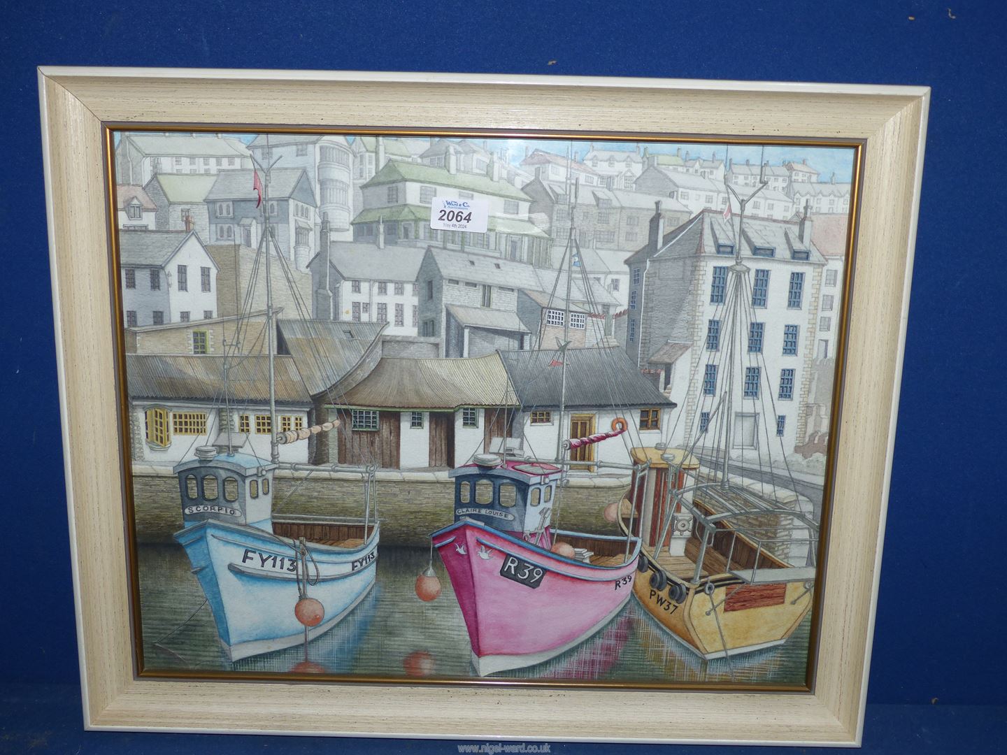 A framed watercolour of a Fishing Town with Three boats moored in the Harbour, no visible signature,