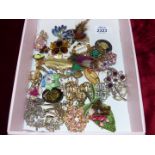 A box containing a wide variety of brooches to include "Movietex", 925 sterling silver, marcasite,