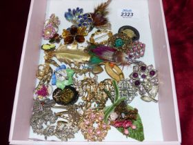 A box containing a wide variety of brooches to include "Movietex", 925 sterling silver, marcasite,
