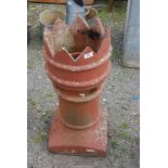 A large terracotta chimney top with crown feature, 30" high.