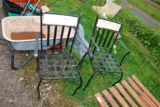 Two black painted metal garden chairs.
