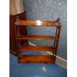 A Mahogany wall hanging shelf unit with three lower drawers.