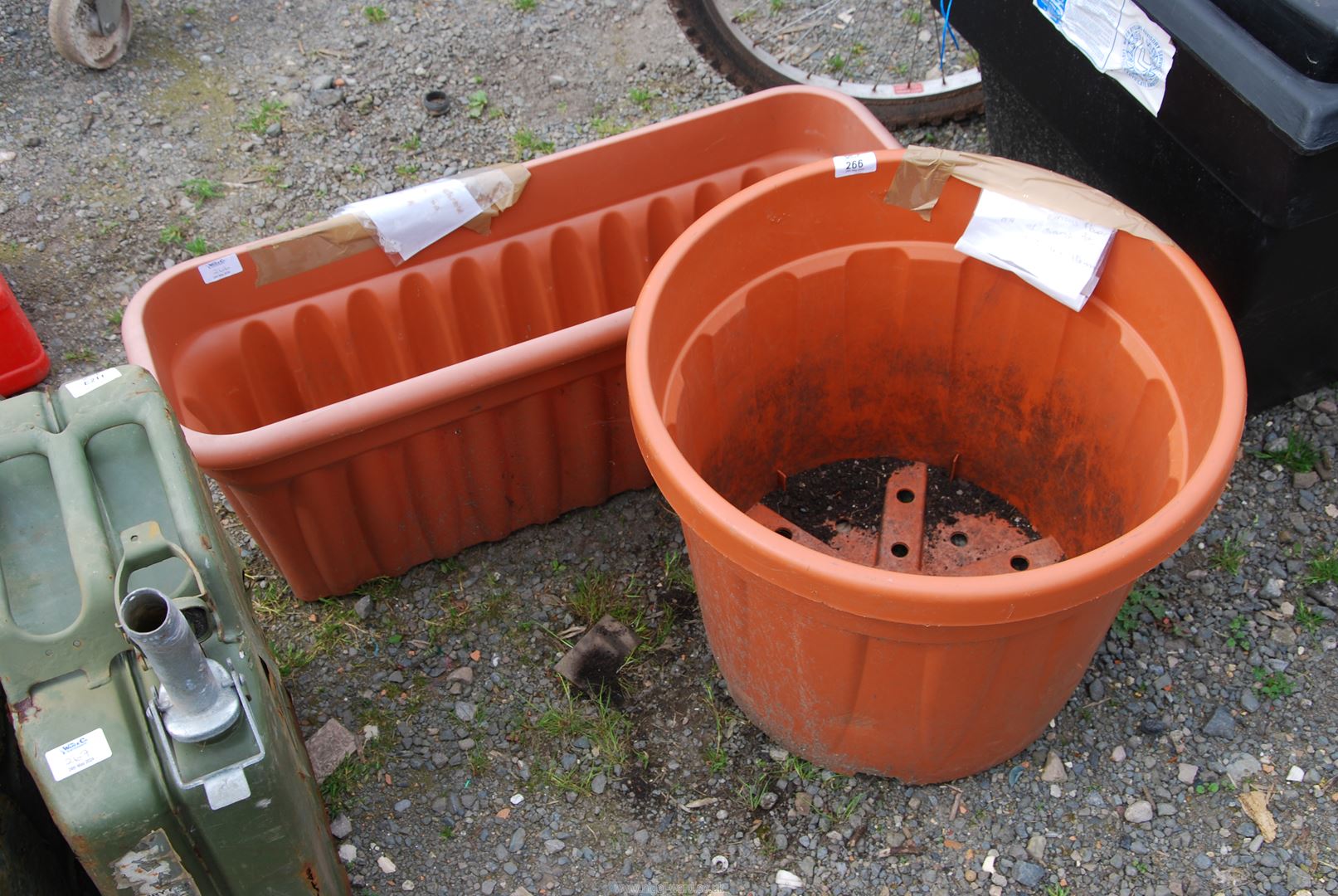 Two large plastic planters.