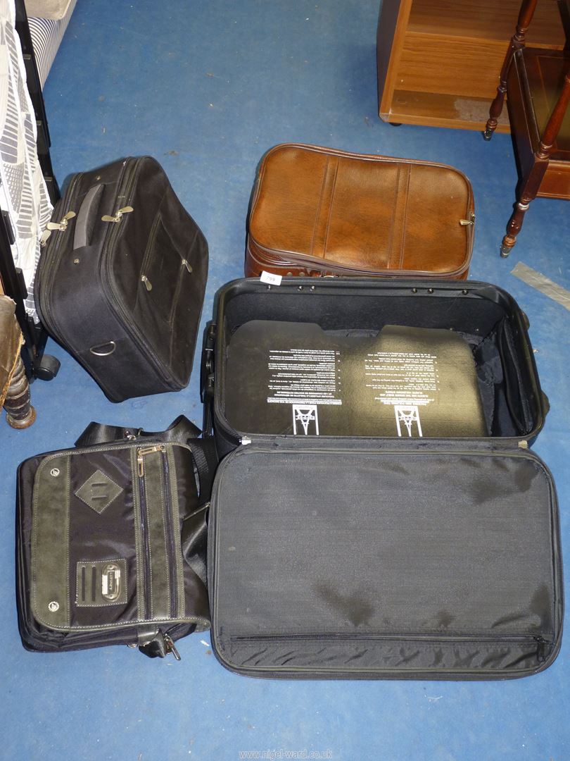 A leather suitcase and other cases.