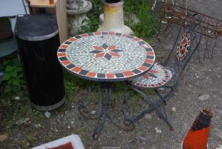 A Bistro table and chair with mosaic top and seat.