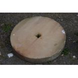 A large wet stone, 24 1/2" diameter x 4" thick.