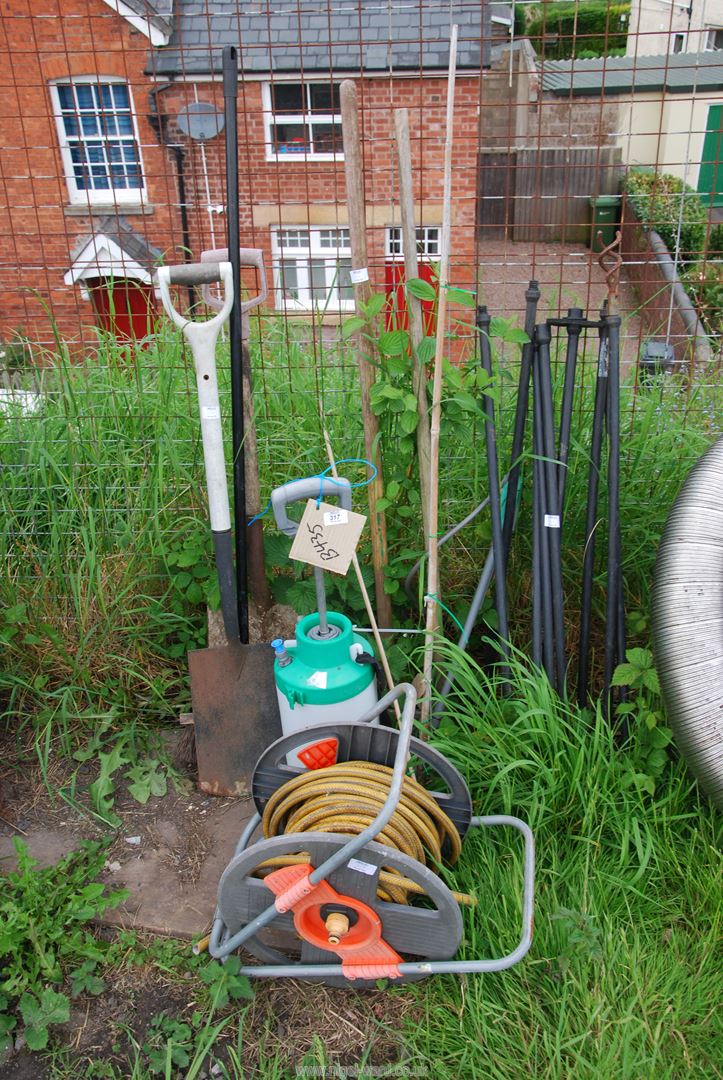 A hose on reel, garden sprayer, drain rods, garden tools etc.