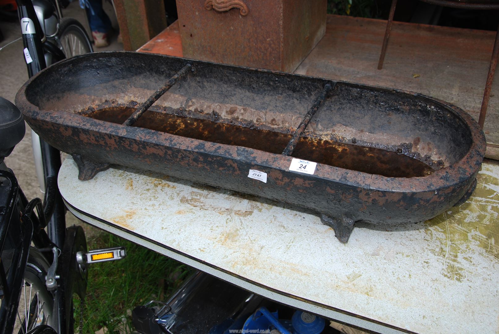 A cast iron pig trough/planter, 35" long x 12" x 6" high.