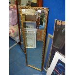 A gilt framed mirror.