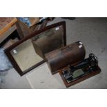A mirror and a "Singer" hand operated sewing machine No 99 with instruction book.