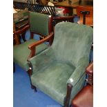 Two green upholstered chairs, one being a dining chair and one a hall chair.