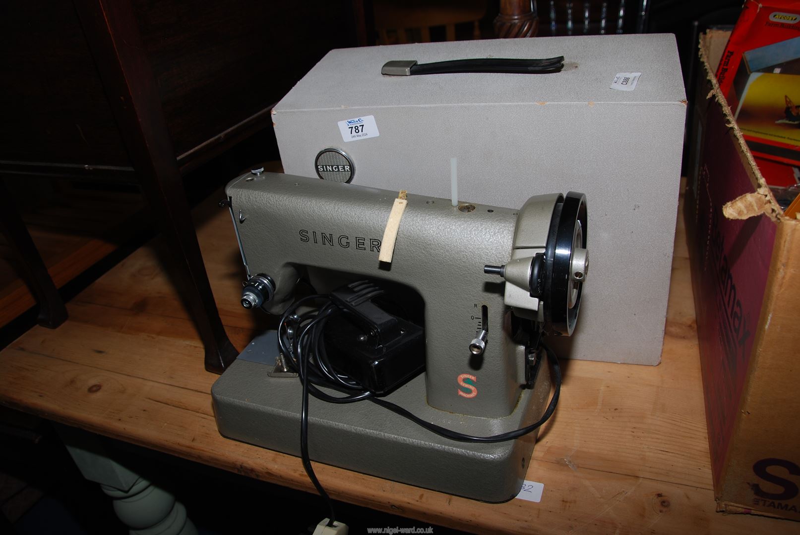 A small "Singer Company" electric sewing machine, cased.