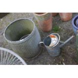 A galvanized can and two planters.