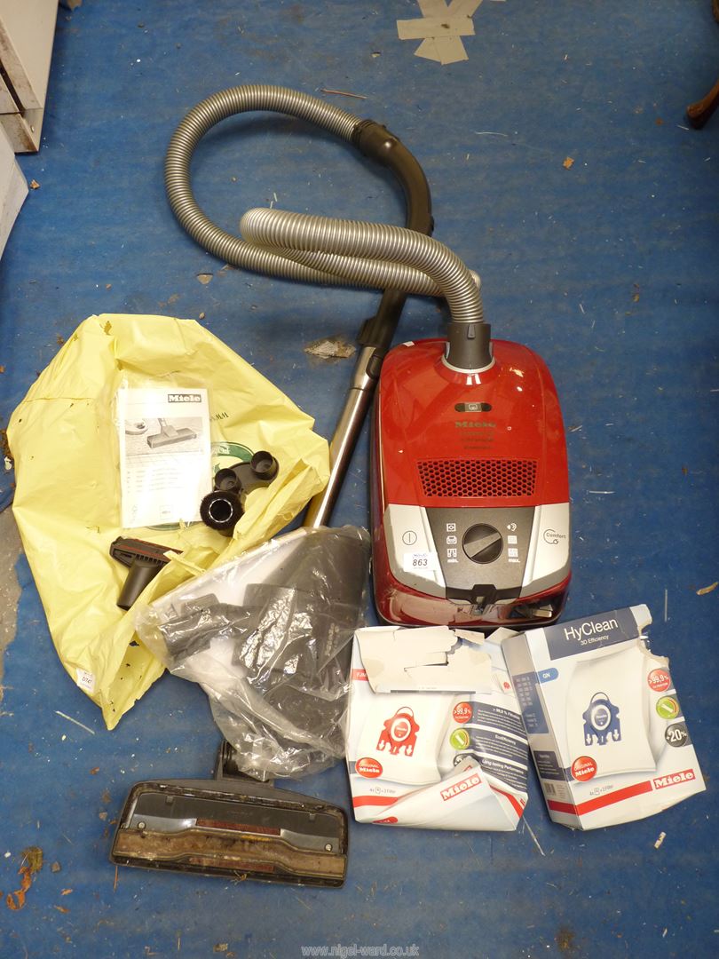 A compact C2 "Miele" vacuum cleaner and attachments plus bags.