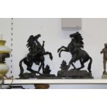 A large pair of black cast metal "Marley" style rearing horse figures,