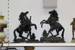 A large pair of black cast metal "Marley" style rearing horse figures,