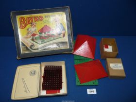 A vintage Bayko building set and scene, with extra pieces.