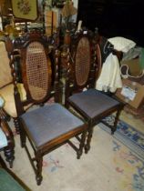 A pair of Oak framed Hall Chairs standing on twist front legs united by an "H" stretcher,