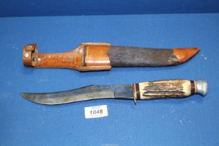 A Solingen Siberian skinner knife (Germany) having an antler handle and a hide sheath.