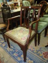 An elegant Georgian Mahogany open armed carver/elbow Chair having stylised floral bosses to the