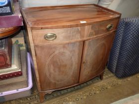 A Mahogany bow fronted Cabinet having a pair of opposing doors with oval Boxwood stringing,