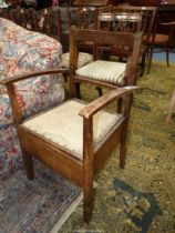 A Satinwood framed open armed Commode Chair (not furnished).