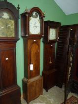 A boxwood strung Mahogany cased Longcase Clock having an arched dial with Arabic numerals,