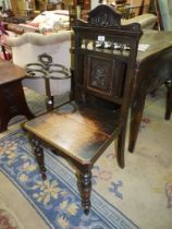 A circa 1900 Oak solid seated Hall Chair having turned bobbin details to the carved backrest and