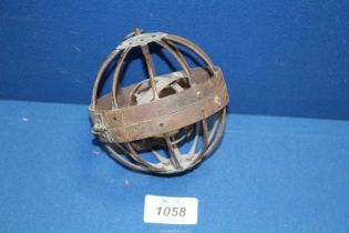 A Gimbal Ship's oil lamp in a metal spherical cage, 4" diameter.