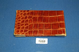 A brown crocodile skin Leather wallet with 9ct gold bound corners, 7" x 4 1/2".