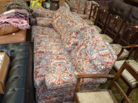 A four piece Lounge Suite comprising a three seater settee, a pair of chairs and a pouffee,