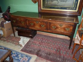 A peg-joyned Oak Welsh Dresser base standing on square legs and having three deep drawers with