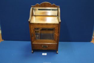 A Smoker's Cabinet with lower drawer, bevelled glass door and mirrored back,