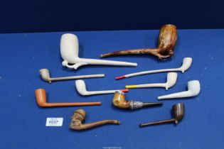 A collection of nine clay Pipes including two large examples of a booted foot kicking a football,