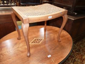 A light Mahogany cane seated Dressing Stool standing on cabriole legs, 21" x 16" x 17 1/2" high.