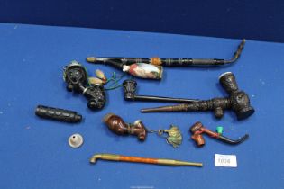 A number of antique pipes including a ceramic long stem continental pipe, an opium pipe, etc.