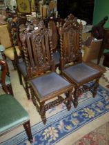 A pair of carved Oak framed Hall Chairs standing on turned and twist legs and stretchers,