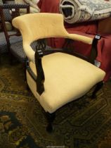 A bowed back black framed Armchair, upholstered in yellow fabric.