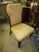 A Mahogany framed beige upholstered Chair standing on mirrored twist front legs.