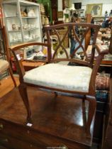 A lattice back open armed Elbow Chair standing on square section cabriole legs,