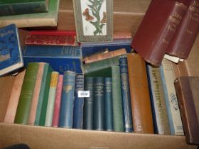 A box of books including 'Peter Pan and Wendy', 'British Flora', 'Flowers of The Field',