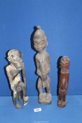 Three carved wood tribal type figures of men, one with distressed, hand-woven wrap/sash,