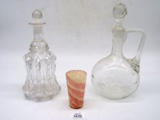 Two decanters with stoppers and a small pink and white beaker.