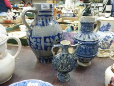 A German stoneware Jug with bands of incised geometric and foliage decoration alternating with